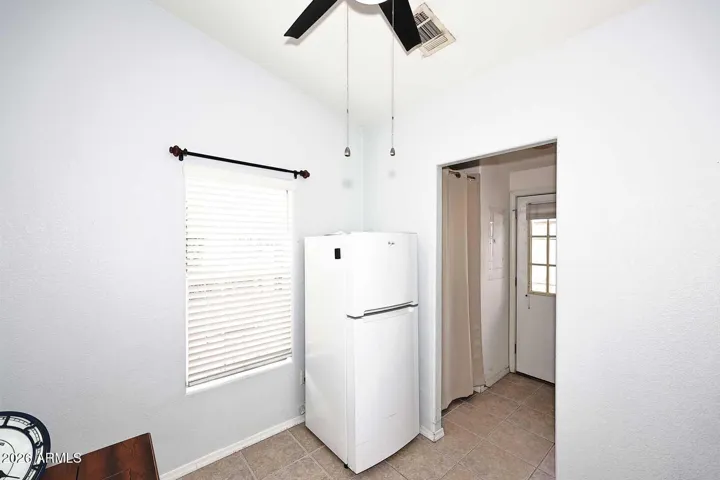 Bonus room off the kitchen by the laundry room. Laundry room has cabinets and door to the backyard