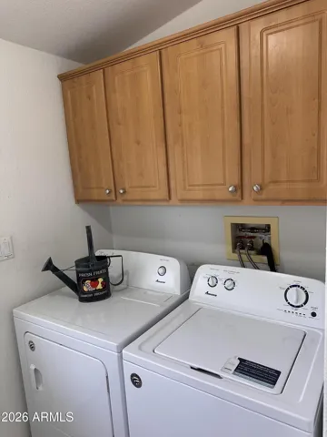 Laundry room with cabinets washer and dryer included