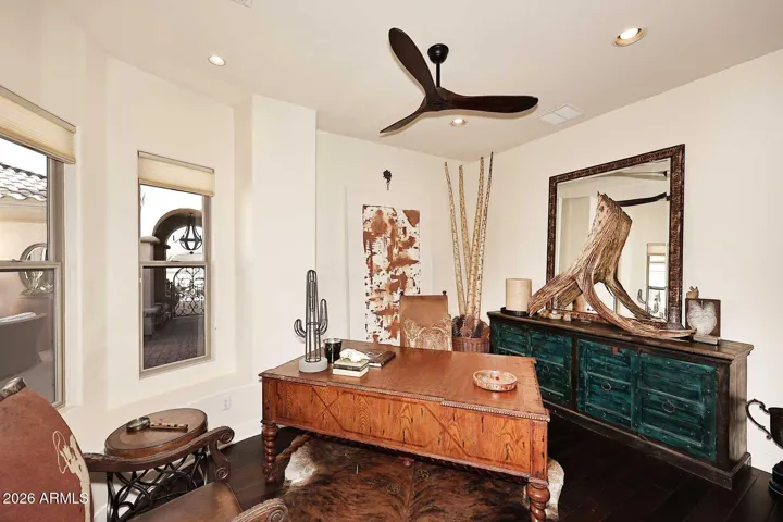 Office overlooking gated courtyard features wood flooring