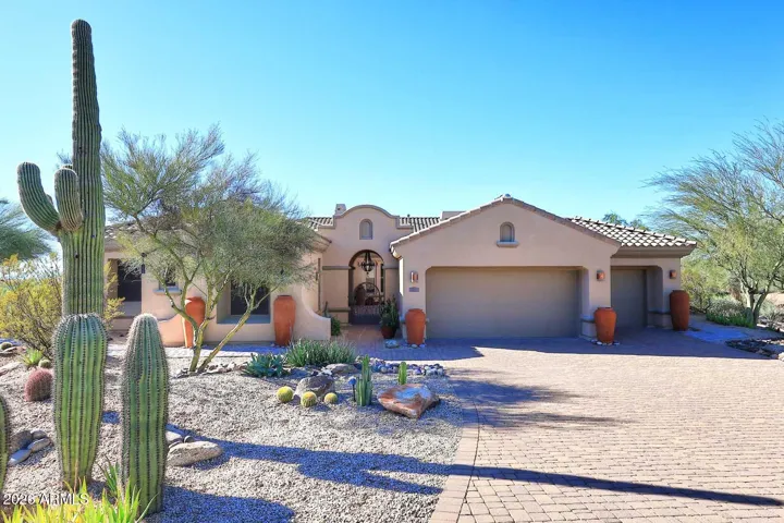 Beautiful pavered driveway leads to 3-car garage