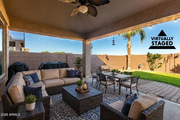The patio has been virtually staged to show outdoor furniture and an dining area.