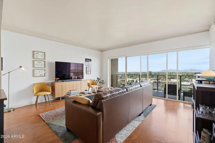 Expansive patio door allowing abundant fresh air and natural light, creating a bright and airy living space. This feature frames beautiful day and night views of the surrounding cityscape and distant mountain scenery, enhancing the indoor-outdoor lifestyle for Central Phoenix Condo Owners.