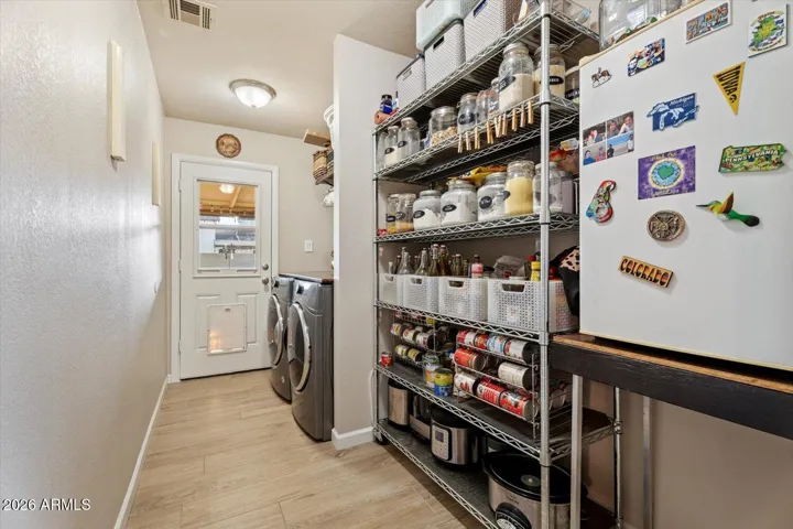 Utility room with lots of storage, washer and dryer and access to backyard.