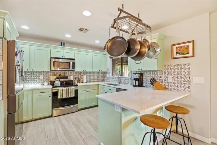 Freshly painted, designer backsplash and new energy efficient appliances complete this fantastic home kitchen.