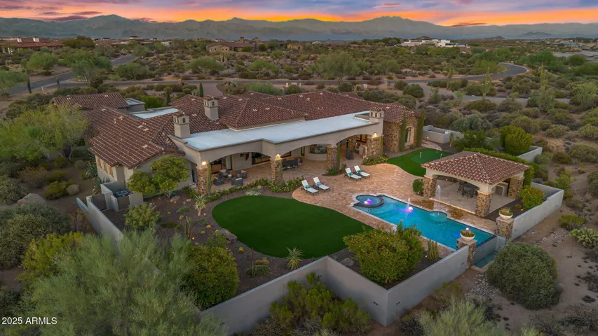Breathtaking drone view of the property featuring the infinity edge pool and serene natural surroundings.