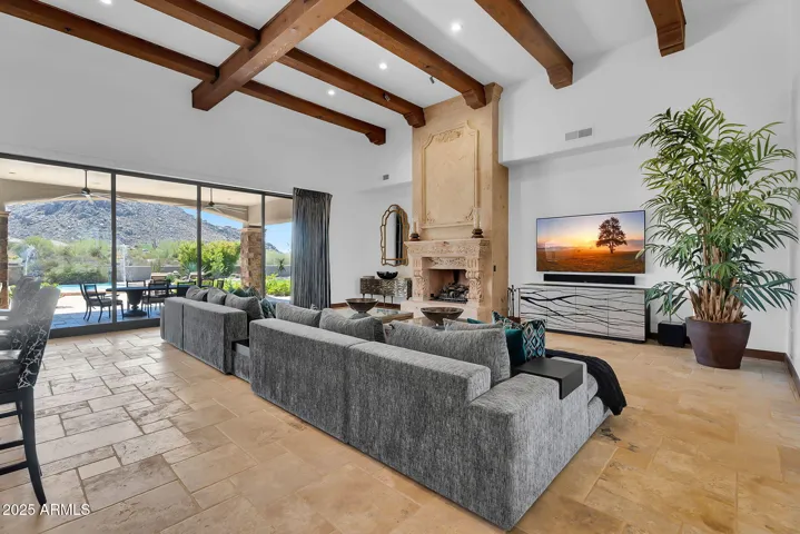 Luxury great room with sliding pocket doors, natural light, and uninterrupted views of Troon Mountain