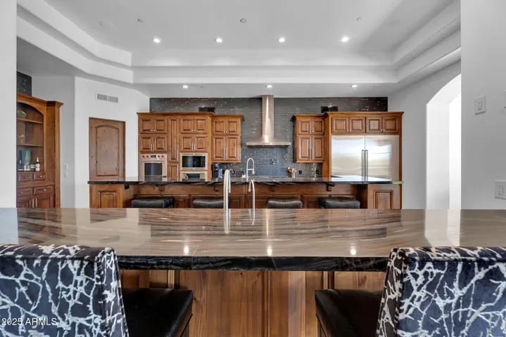 Elegant kitchen with dual marble island, seamlessly balancing entertaining and everyday functionality.