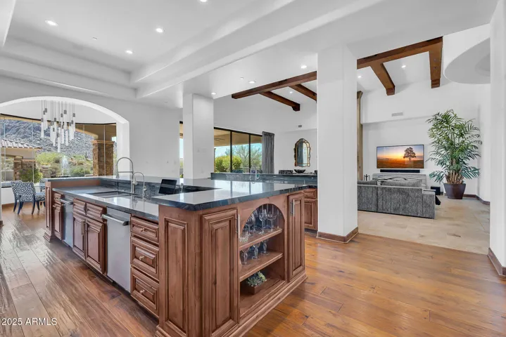 Open and inviting kitchen ideal for gatherings, with marble dual islands, premium finishes, and seamless flow to the great room
