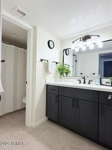 Spacious bathroom newly designed vanity area and private toilet/shower space