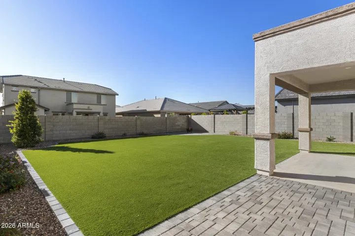 Large backyard with turf and pavers