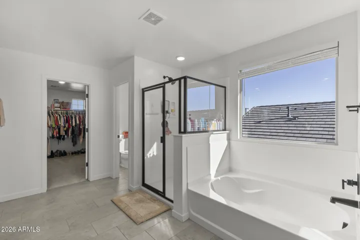 Primary bathroom - glimpse of large walk in closet