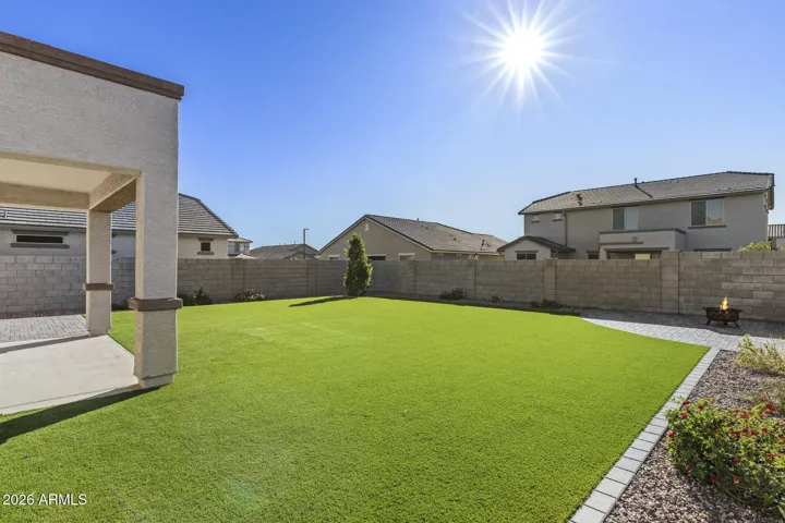 Large backyard with turf and pavers
