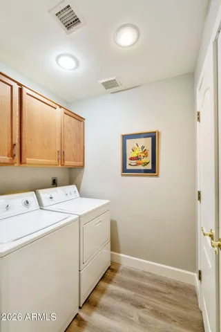 INDOOR LAUNDRY ROOM WITH CONVENIENT CABINETS