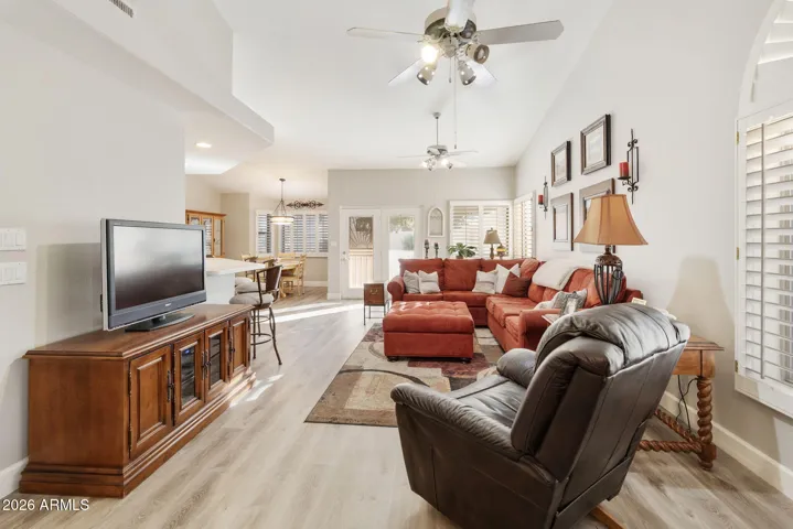 LIGHT AND BRIGHT LIVING AREA WITH SOARING CEILINGS ADORNED IN COOL TONES