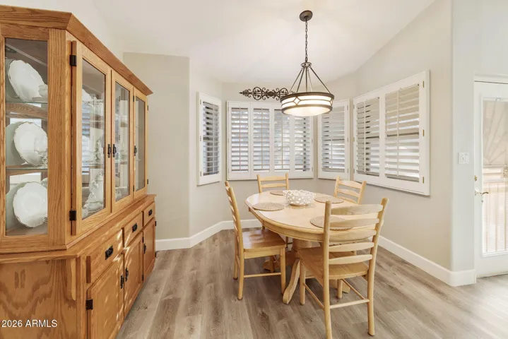 DINING NOOK SURROUNDED BT SHUTTERED WINDOWS
