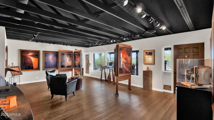 A light-filled bonus room currently styled as an art gallery, easily reimagined as a den, office, or additional living space