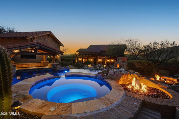 Accented with waterfall feature, fire feature and 13' lighted umbrella
