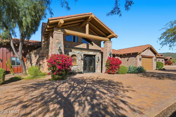 Stone construction with steel accent walls and Vega beam exterior rafter tails