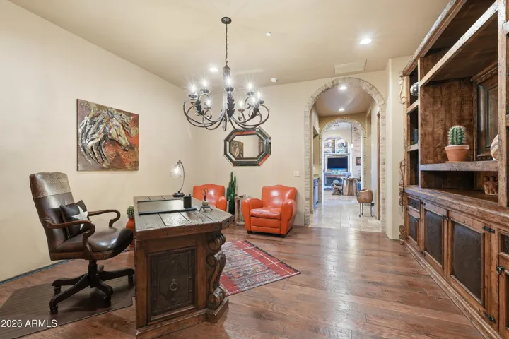 Custom-built lighted cabinetry, brick arched entry