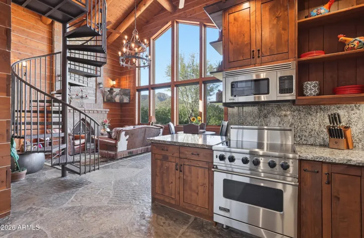 Chiseled granite counters,
knotty alder cabinetry