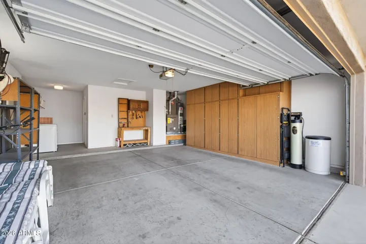 The garage has cabinets & a water softener system.