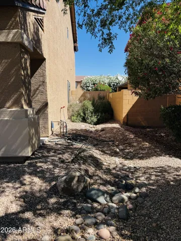 Side yard with thoughtfully designed, low-maintenance landscaping