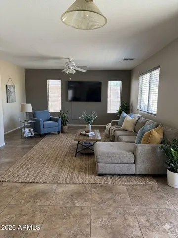 Large family room perfect for relaxing and entertaining - Photos may include AI-generated or enhanced elements; actual property may differ
