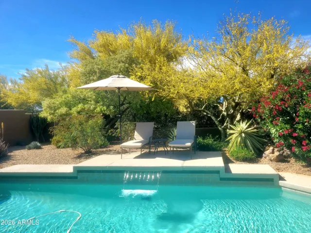Skyranch townhome's largest private pool with secluded open space on two sides and mountain views. Part of the Magic of this original model home.