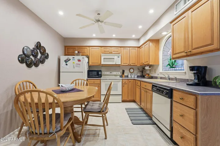 Kitchen with stained glass accent and canned lighting.