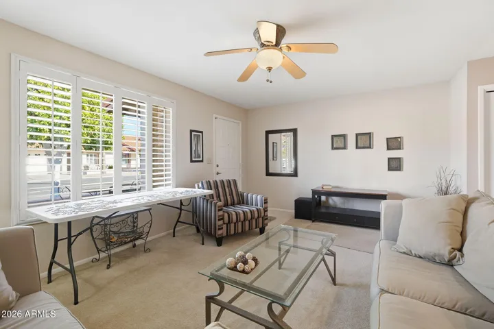 Front living room with north-facing window with plantation shutters.