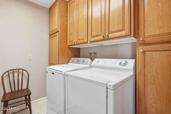 Inside Laundry Room with cabinetry.