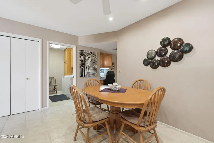 Dining area in kitchen with view of pantry and inside laundry room with access to garage.