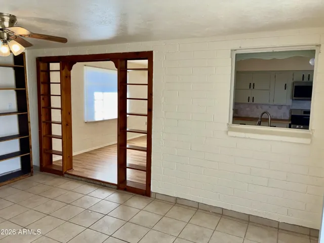 Private F Room in the back of the home has a convenient Kitchen Pass-Through, and Quaint Book-Shelf Design.