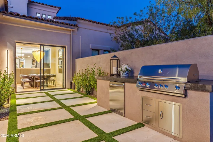 Outdoor kitchen with gas grill and refrigerator