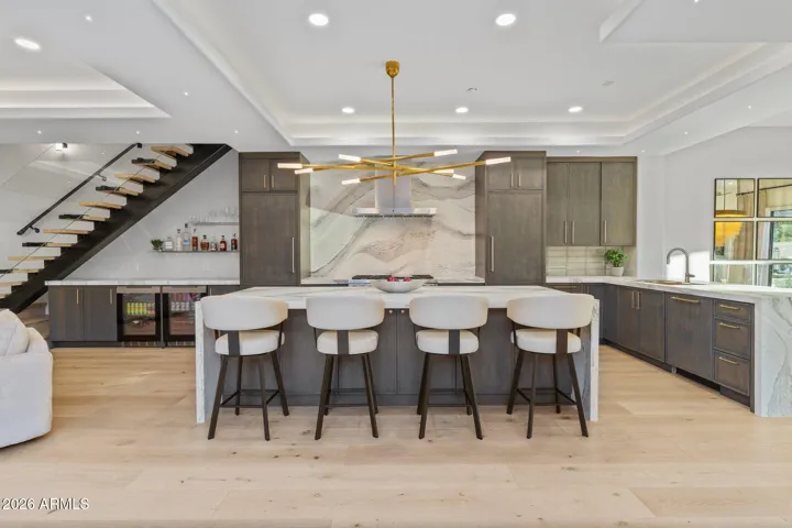 Kitchen with Wolf, Sub-Zero and Cove. Beautiful quartz countertops with gold flecks
