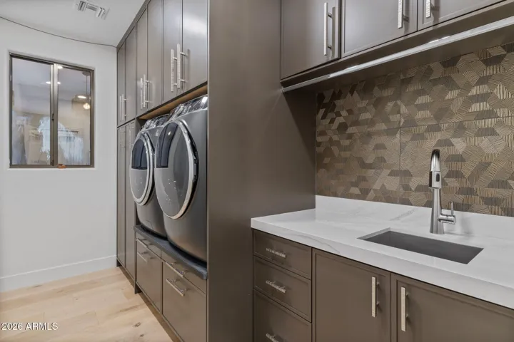 Laundry with well thought out cabinets and folding trays