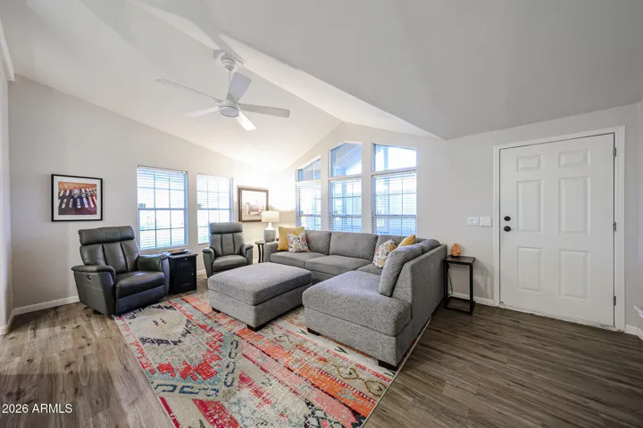 Front room has large windows and plank floors