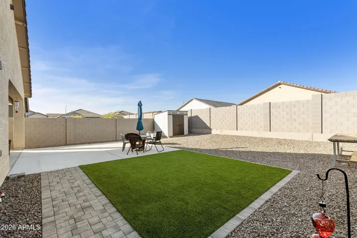 BACKYARD IS FINISHED WIT HARTICIAL TURF, PAVERS AND A SHED