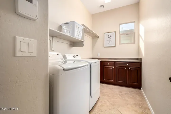 Large laundry room with storage and counter space