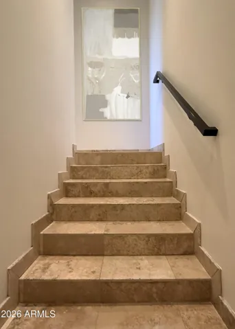 Interior steps to the attached , large 3 car garage with storage.