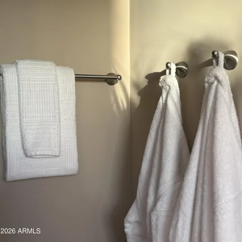 Primary shower entry. Two shower heads, and resort style bench are spa inspired
