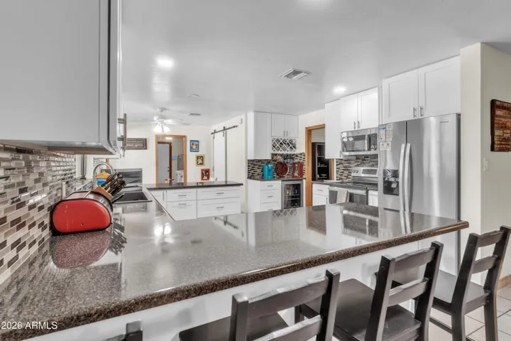 From the fireplace room to the kitchen, the home feels connected — open sightlines, refreshed finishes, and space designed for everyday living.