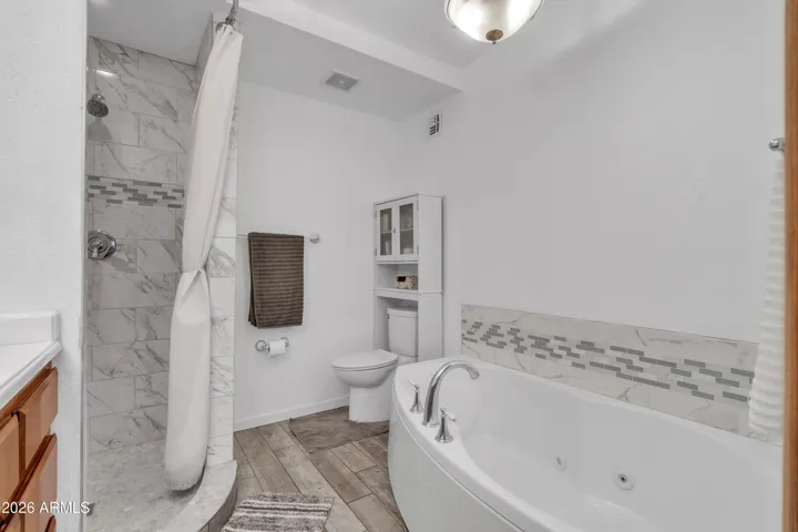 A primary bath designed for everyday comfort, featuring a newer soaking tub and separate shower.