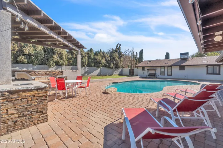 This is Arizona living — poolside lounge chairs, BBQ nearby, and a backyard made for relaxing, gathering, and celebrating.
