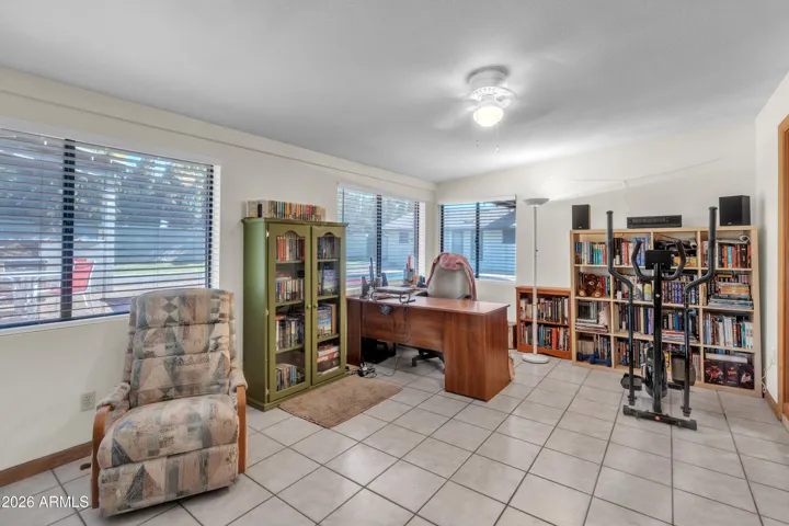 A flexible den filled with natural light — glass doors, walls of windows, and exterior access create space for work, creativity, or retreat.