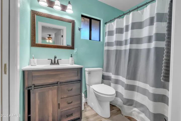 Sizable guest house second bedroom with its own bathroom featuring a tub/shower combo.