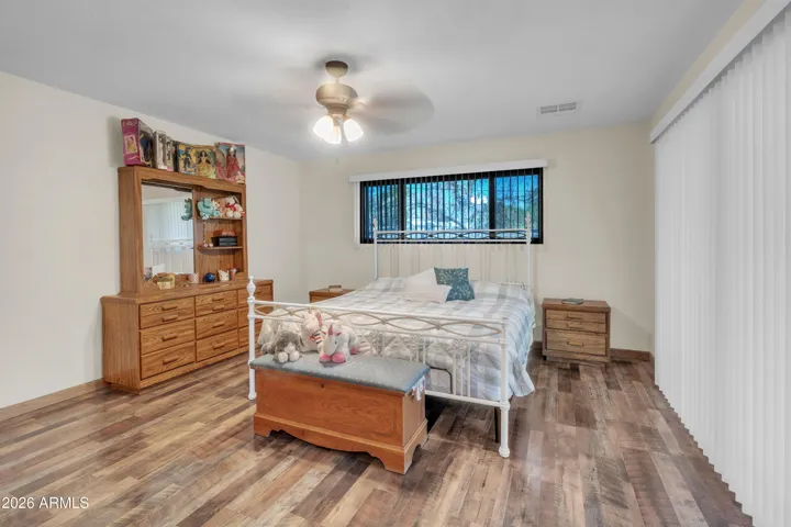 Additional primary bedroom view showing natural light, window placement, and comfortable layout.