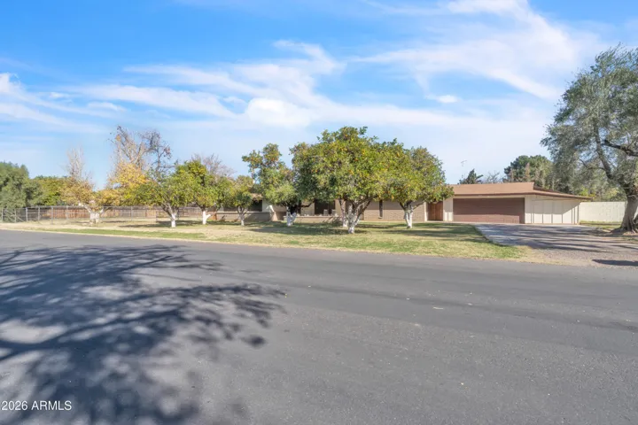 A corner-lot property with presence — mature landscaping, open frontage, and the kind of space that sets this home apart.