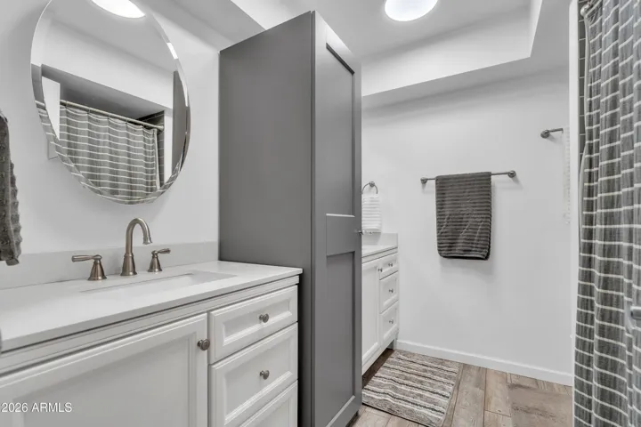 A beautifully refreshed hall bath — bright, clean, and updated in classic gray-and-white finishes.