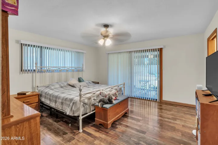 Primary bedroom with direct pool access through an Arcadia door, creating an easy indoor-outdoor connection.